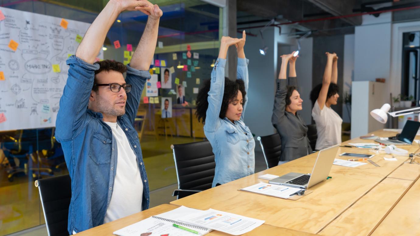 Employees taking an active movement break in a modern office