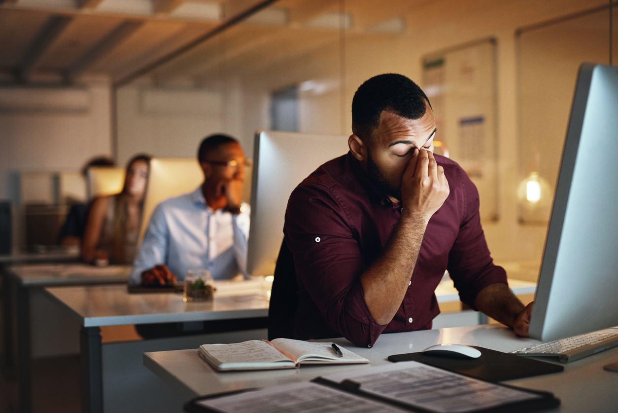Office worker practicing eye rest technique away from computer screen